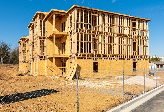 a close-up of temporary chain link fences enclosing a construction site, signaling progress in the project's development in Flower Mound